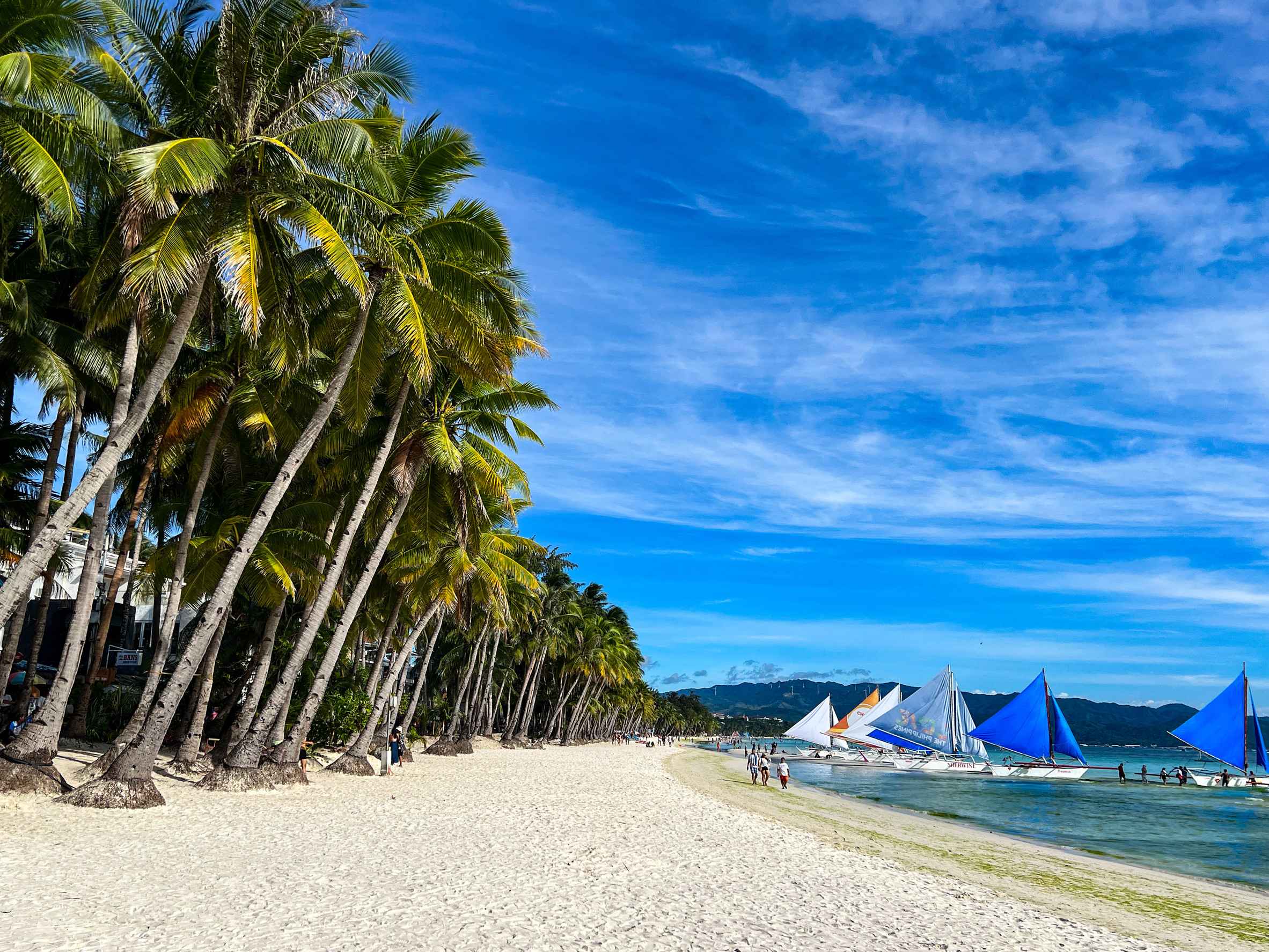 Boracay white sand beach with sailboats