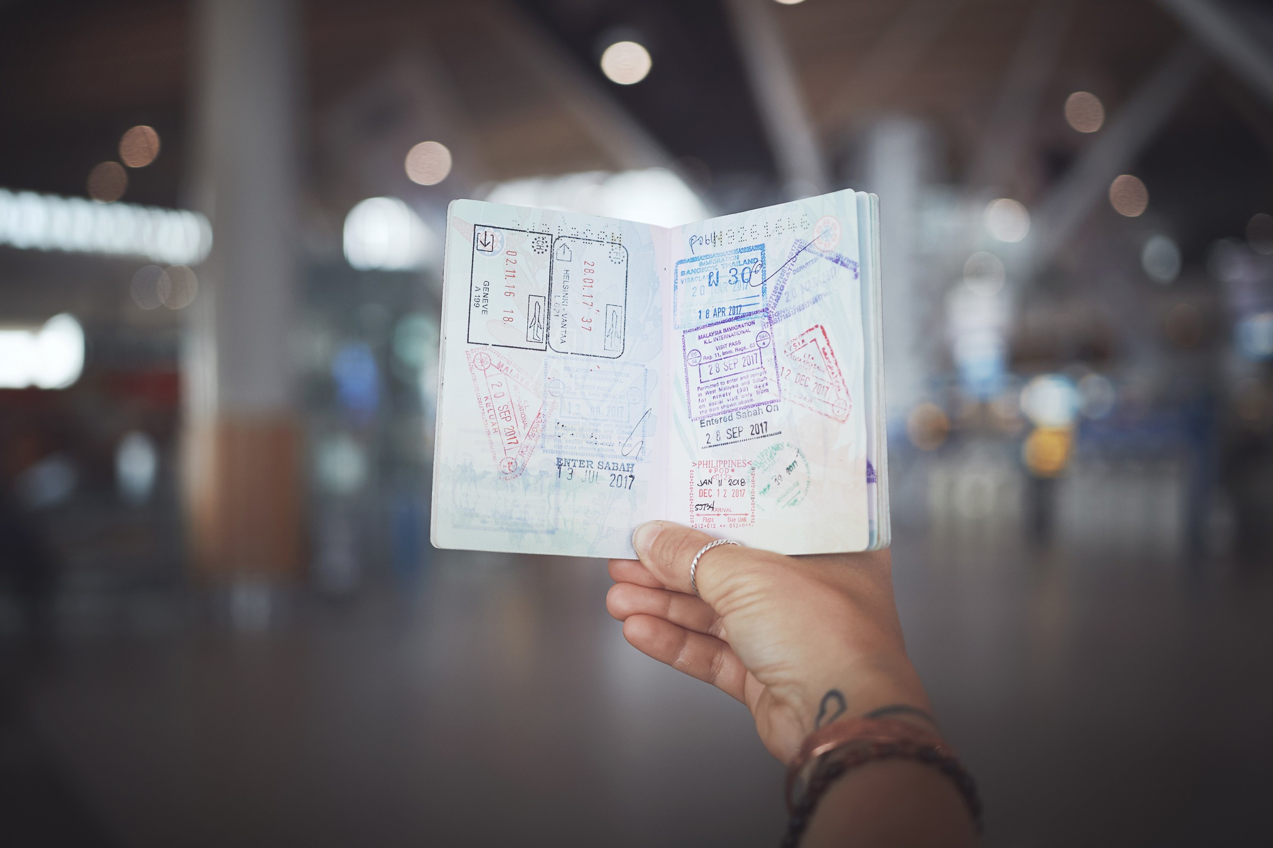 A woman showing her passport stamps at the airport