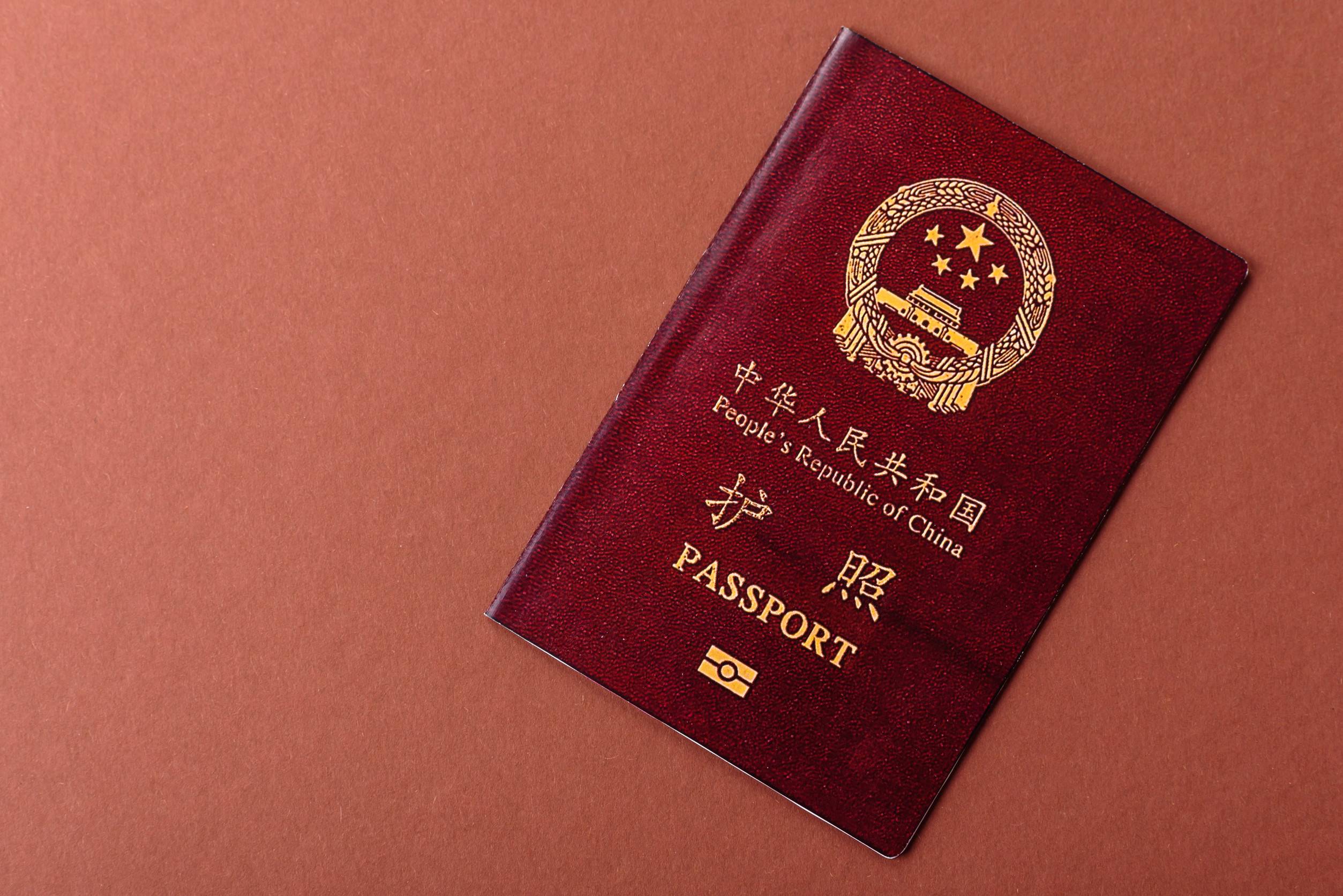 Chinese passport on brown background