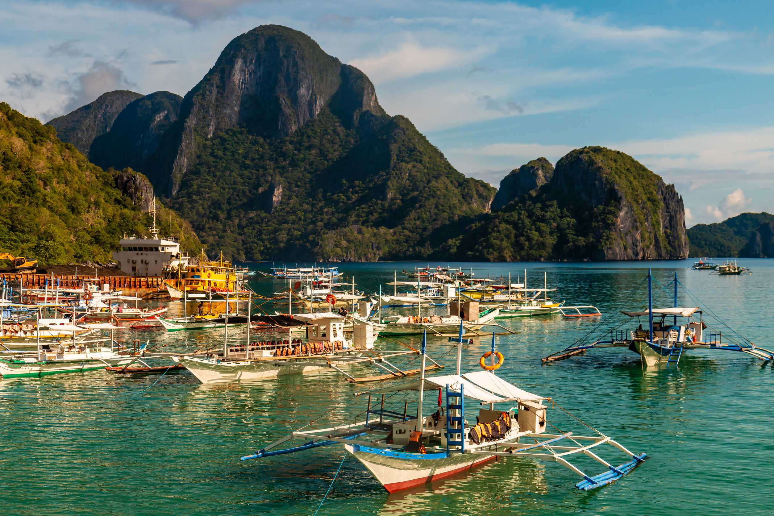 Hundreds of traditional wooden banca boats wait at a port in El Nido Palawan