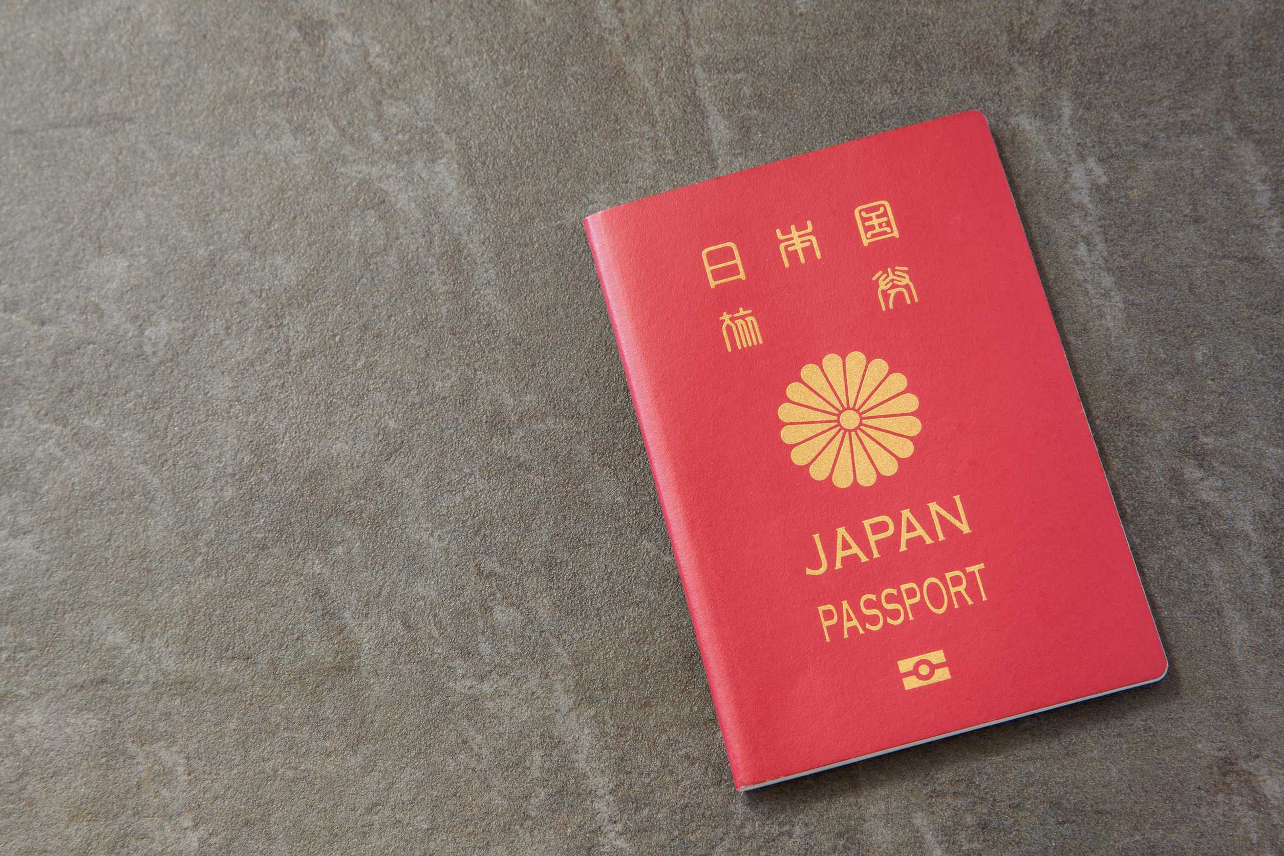 Japanese passport on grey surface