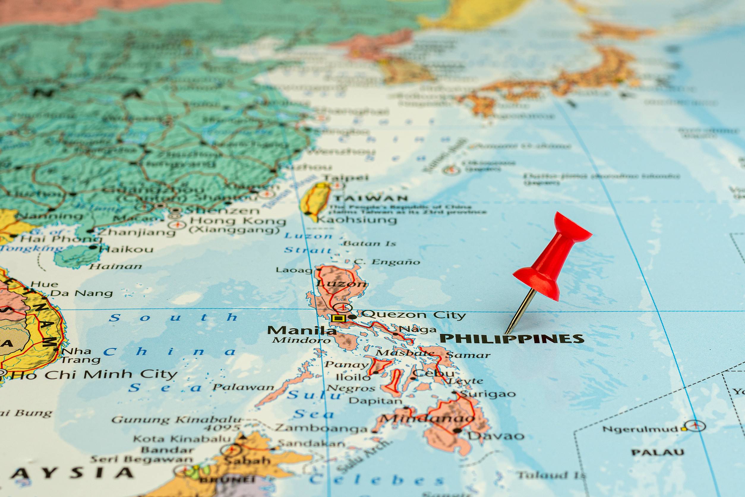Red pin placed selective at Philippines map economic and business concept
