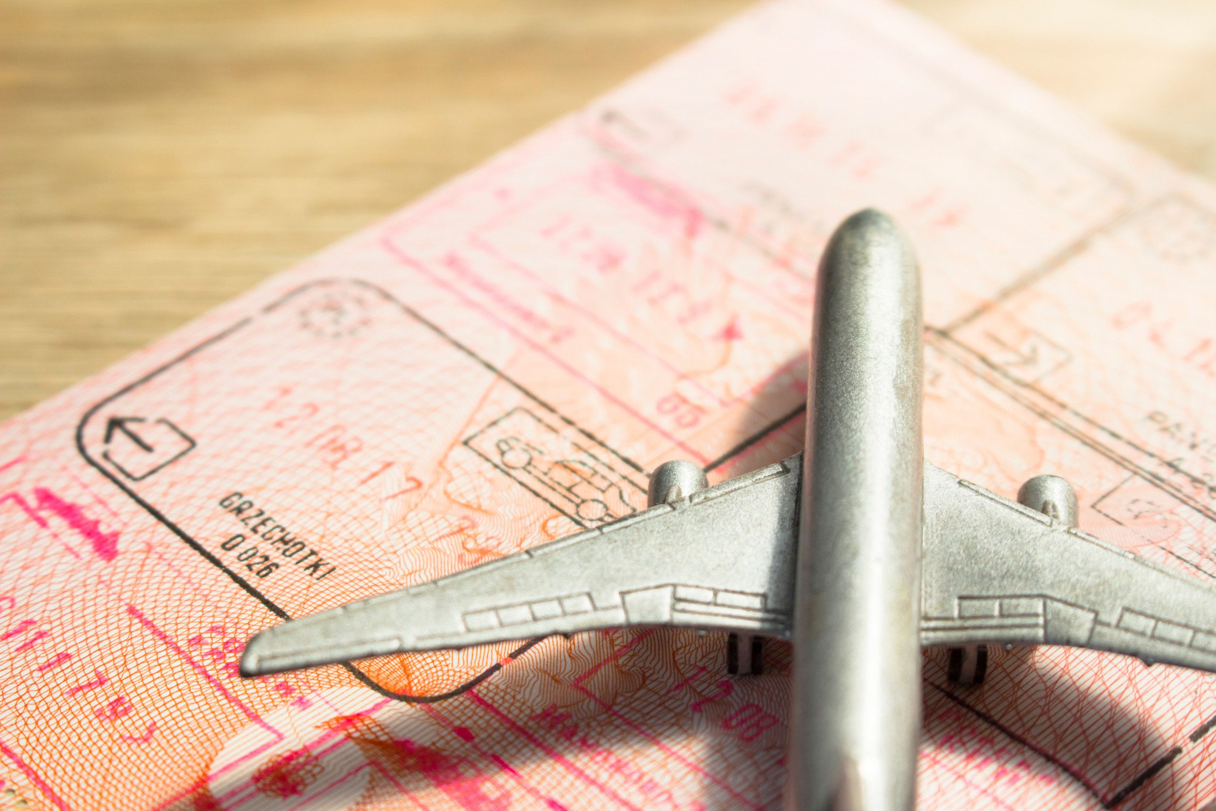 Small toy airplane on a foreign passport
