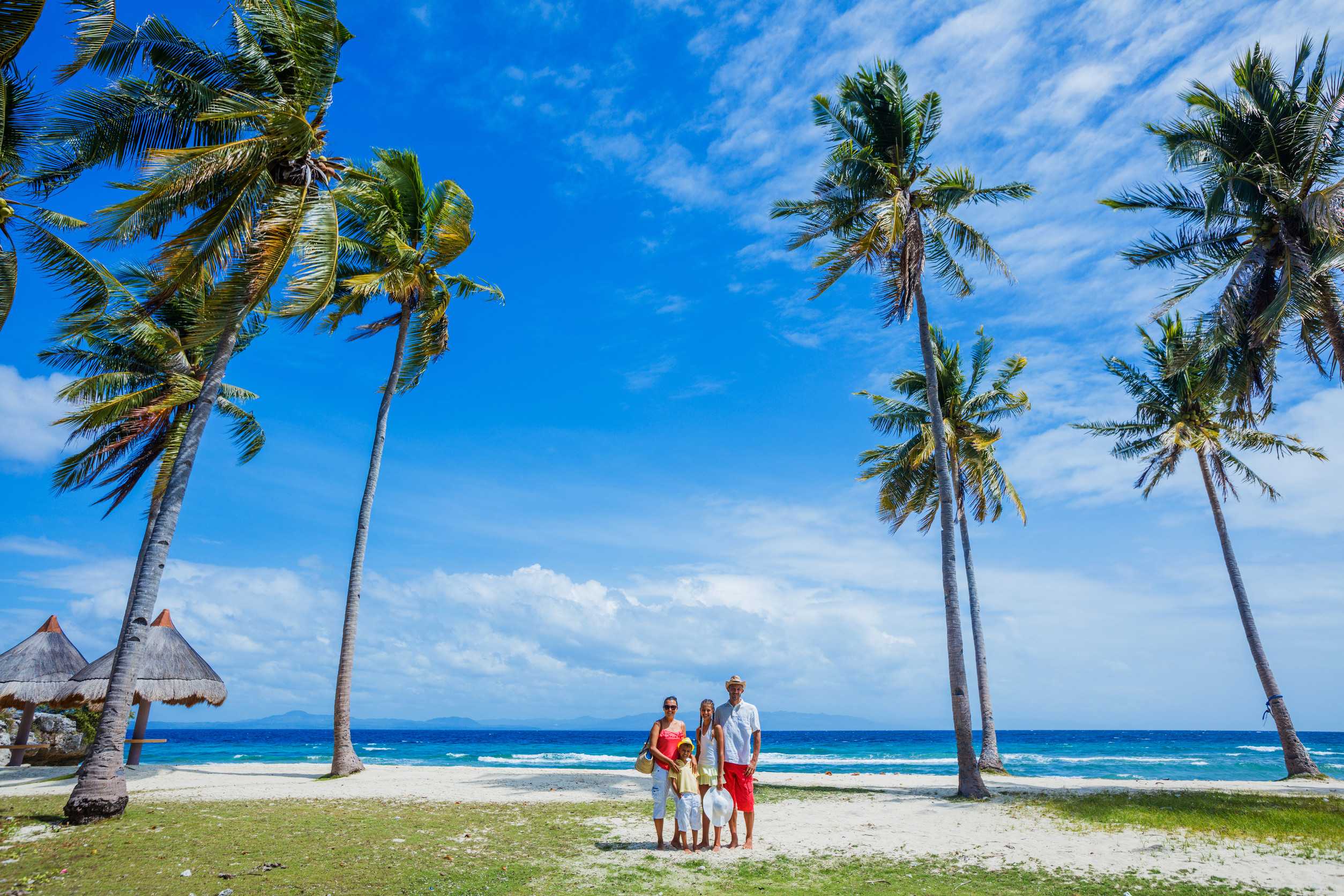 Young family with two kids at tropical beach